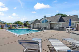 View of pool with a patio area and a mountain view