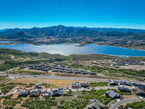 Drone / aerial view featuring a water and mountain view