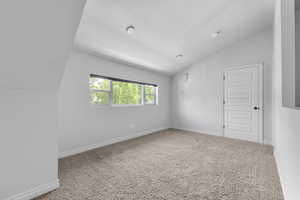 Carpeted living upstairs living room featuring lofted ceiling