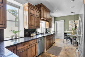 Kitchen featuring stainless steel appliances, deep window ledges, tile flooring and granite countertops