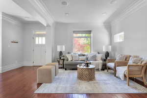 Front entrance and Living room with crown molding and hardwood / wood-style floors