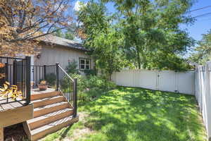 View of yard with a wooden deck