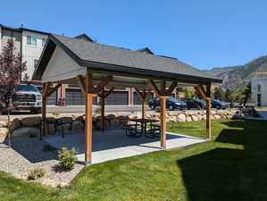 Exterior space with a mountain view, a patio area, and a yard