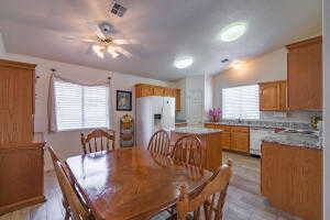 Dining area with light hardwood / wood-style flooring and ceiling fan