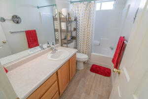 Full bathroom with vanity, toilet, wood-type flooring, and shower / bath combo