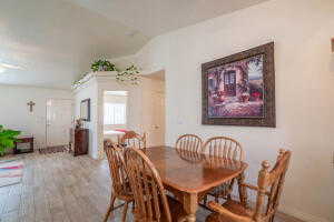 Dining room with lofted ceiling and light hardwood / wood-style floors