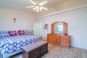 Bedroom with ceiling fan and light hardwood / wood-style flooring