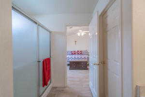 Corridor with hardwood / wood-style floors