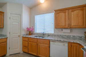 Kitchen featuring white dishwasher and sink