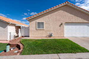 View of home's exterior featuring a garage and a yard