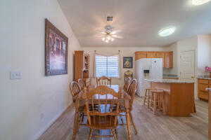 Dining room with ceiling fan and light hardwood / wood-style flooring