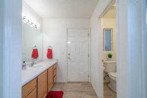 Bathroom featuring vanity, toilet, and hardwood / wood-style floors