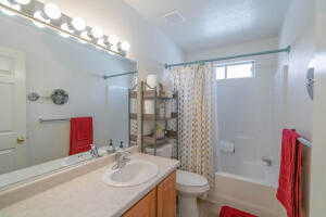 Full bathroom featuring shower / bathtub combination with curtain, toilet, and vanity