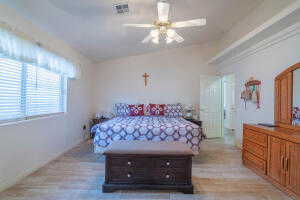 Bedroom featuring lofted ceiling, hardwood / wood-style floors, and ceiling fan