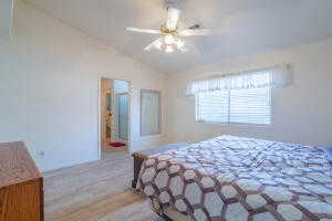 Bedroom featuring lofted ceiling, ceiling fan, and wood-type flooring