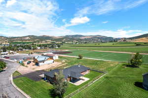 Birds eye view of property with a mountain view and a rural view