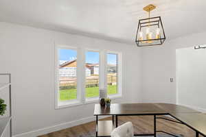 Office with an inviting chandelier and hardwood / wood-style floors