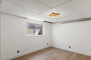 Newly Completed 4th Bedroom. Unfurnished room featuring hardwood / wood-style flooring and a drop ceiling