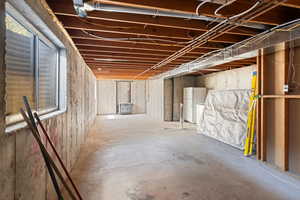 Basement featuring white fridge