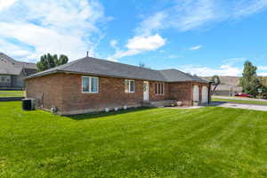 View of front of house featuring a front lawn and central AC unit