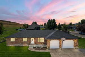 Ranch-style home with a yard and a garage