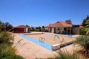 Surrounding community with a patio, a storage unit, and a pool