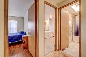 Corridor with light carpet and a textured ceiling