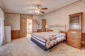 Carpeted bedroom with ceiling fan