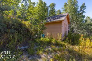 View of side of property featuring a storage unit