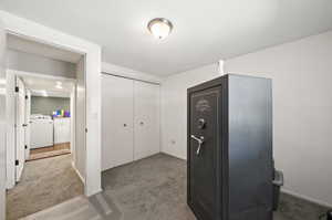 Interior space featuring washer / clothes dryer and light colored carpet