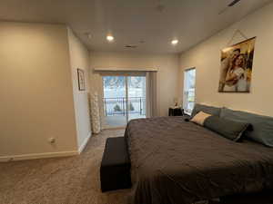 Carpeted bedroom with access to exterior