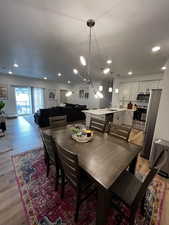 Dining area featuring light hardwood / wood-style flooring, an inviting chandelier, and sink