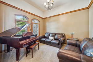 Carpeted living room with a chandelier