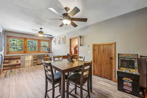 Dining room featuring ceiling fan and light hardwood / wood-style floors