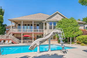 View of pool featuring a water slide and a patio