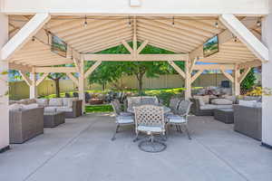 View of patio with an outdoor living space and a gazebo