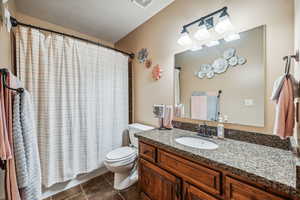 Bathroom featuring vanity, toilet, and tile patterned floors