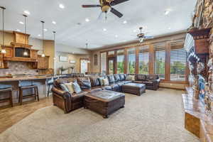 Tiled living room featuring ceiling fan and a fireplace