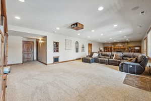 Carpeted living room featuring a fireplace