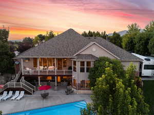 Back house at dusk with a patio