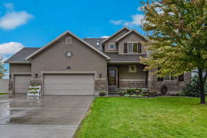 View of front of house featuring a front yard and a garage