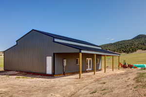 Exterior space featuring a mountain view and an outdoor structure