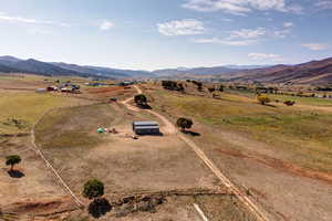 Birds eye view of property with a rural view and a mountain view