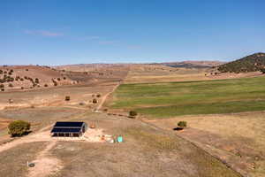 Birds eye view of property with a rural view and a mountain view