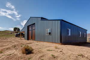 View of outdoor structure featuring a garage