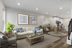 Living room with dark hardwood / wood-style flooring and plenty of natural light