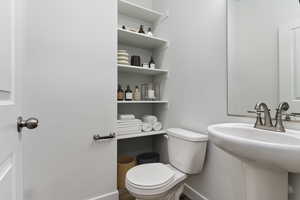 Bathroom with toilet and hardwood / wood-style floors