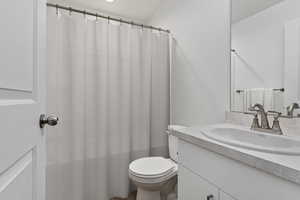 Bathroom featuring vanity and toilet