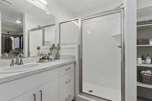 Bathroom with a shower with door and vanity