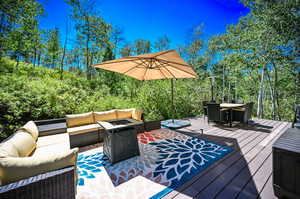 Wooden terrace with an outdoor living space with a fire pit